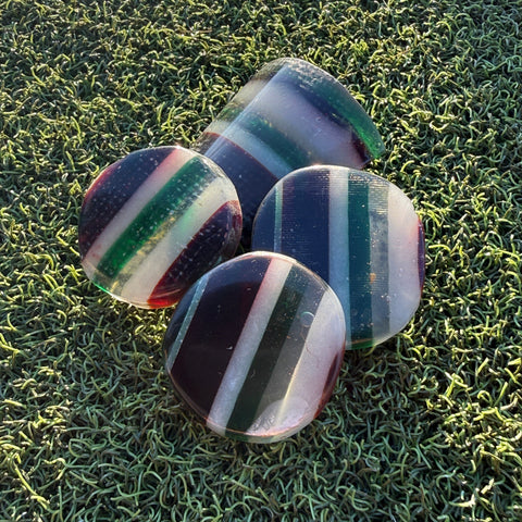 Swell Marks Leftovers handmade resin golf ball markers cut from layered leftover resin and fiberglass.