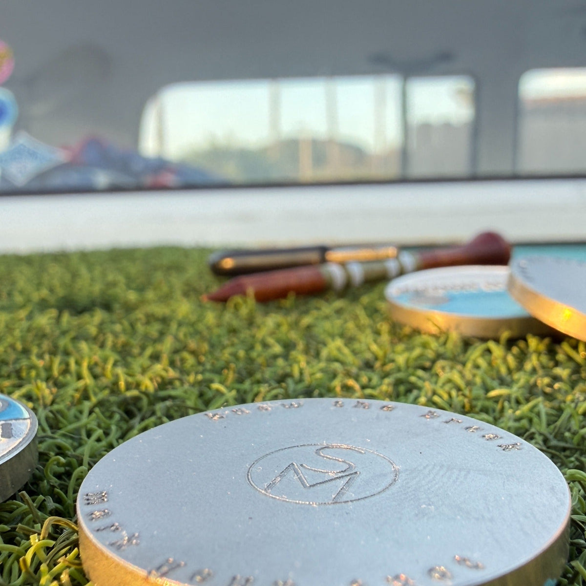 Back of the Zissou stainless steel golf ball marker with Swell Marks monogram and Know the Break. Mark Your Spot. engraving